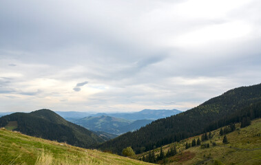 Breathtaking view of green mountains under an overcast sky, highlighting the harmonious connection...