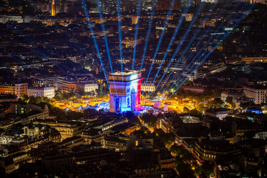 Panoramic Night View of Paris Skyline with Eiffel Tower, Illuminated Cityscape, and Montparnasse Tower Seen from a High Vantage Point during a Clear Evening