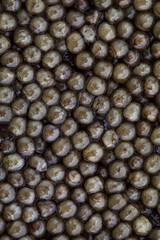 superior grade black caviar background, close-up view