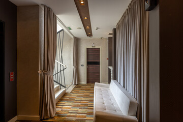 Interior of a hotel corridor with sofa, doorway
