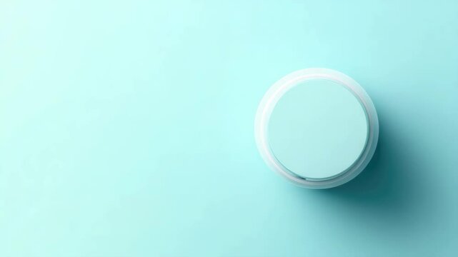 Minimalist top-view mockup of round cosmetic container on soft blue background for product branding concept