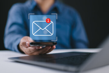 Businessman using email marketing tools on laptop and smartphone, sending newsletters and analyzing campaign performance to engage subscribers and grow business through personalized content