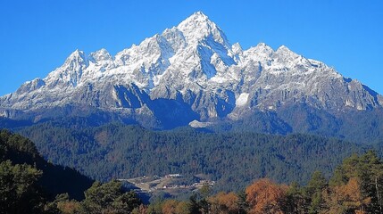 Snowy mountain peak, autumn forest