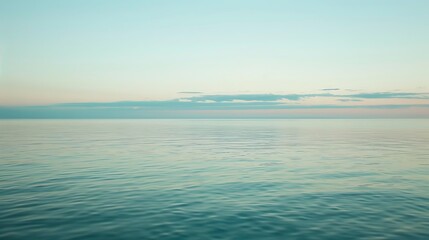 Fototapeta premium Calm Ocean Horizon With Soft Blue Hues And Subtle Cloud Cover