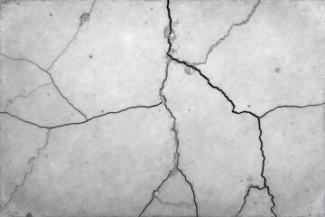 Obraz premium Cracked concrete surface with dark fissures in monochrome style 