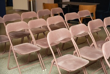 Rows of Velvet Folding Chairs in Conference Room.