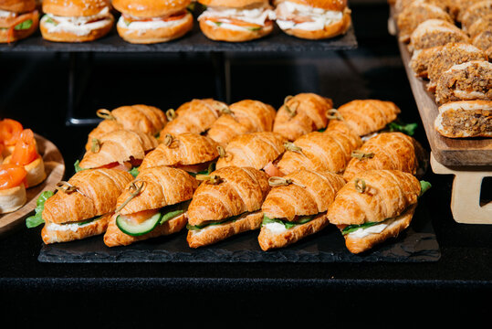 Mini croissant sandwiches on catering display.
