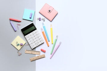 Modern calculator with different stationery on color background