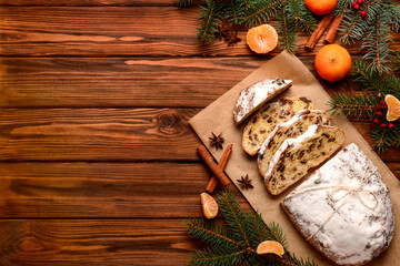 Composition with tasty Christmas stollen on wooden background
