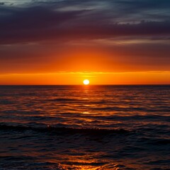 Vibrant Orange Sunset Over Dark Ocean