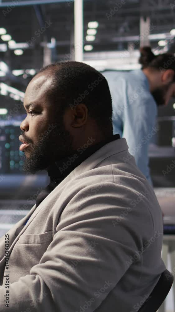 Poster vertical video satisfied data center employee finishing system maintenance on supercomputers. smilin