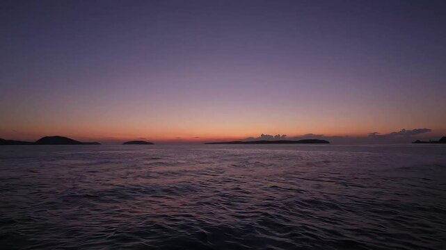  Gentle sunset over the ocean, showcasing warm tones and serene reflections.