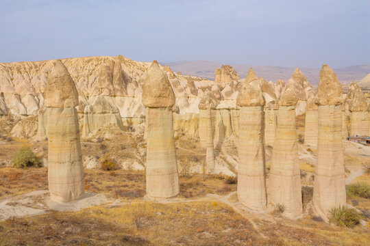 Cappadocia rock formation sites and chimneys. Kapadokya in Turkey, Love Valley. Tuff volcanic rock pillars and mushrooms in the museum under open sky in Cappadocia turkish famous tourist sight