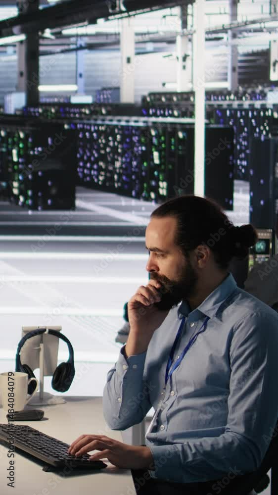 Poster vertical video data center technician discussing with coworker while doing ai software updates. serv