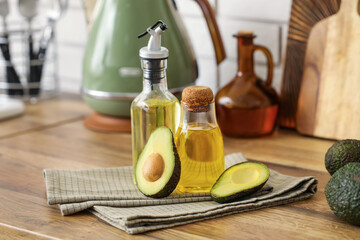 Bottles of fresh avocado oil on wooden table