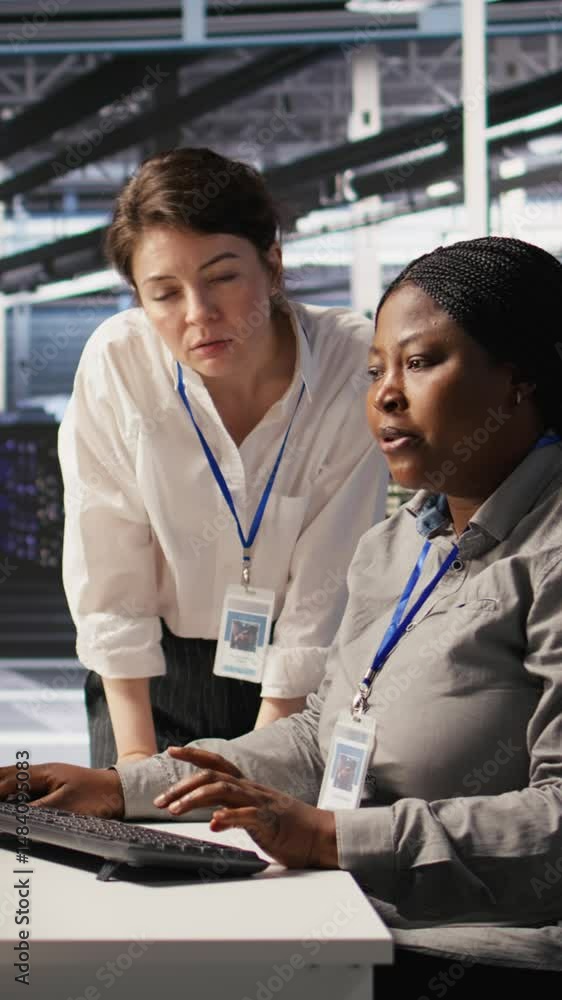 Poster vertical video data center team leader and it expert reviewing performance dashboards of ai equipmen