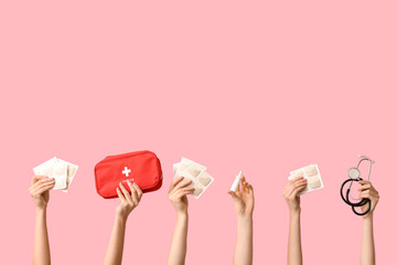 Female hands with mustard plasters, stethoscope, nasal spray and first aid kit on pink background