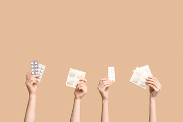 Female hands with mustard plasters and pills on beige background