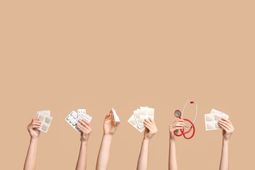 Female hands with mustard plasters, pills, stethoscope and nasal spray on beige background