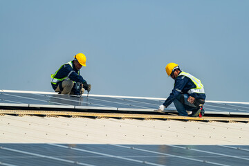 Two engineers install solar panels on a rooftop, wearing safety gear and helmets. The scene showcases renewable energy, green technology, and sustainable solutions under a clear blue sky.