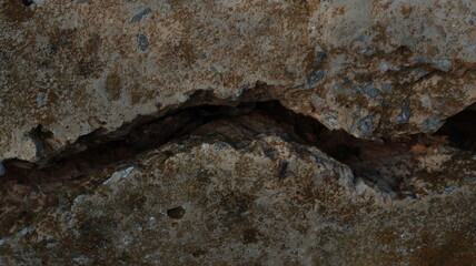 Cracked stone surface with dark fracture line, ideal for geology visuals, erosion concepts, or...
