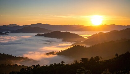 Obraz premium Foggy valley sunrise with layered mountain silhouettes