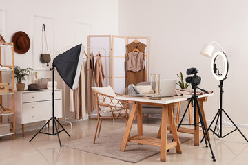 Interior of blogger's studio with workplace, clothes and accessories