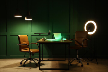 Interior of blogger's studio with workplace and glowing lamps