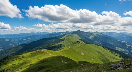 Obraz premium Green mountain ridge representing natural beauty and exploration, with blue sky and clouds