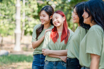 Group of Young Volunteers Women Enjoying Outdoor Time Together in Matching Shirts, Cheerful Group of Diverse Women Posing in Green T-Shirts at the Park