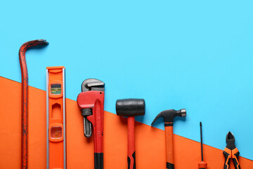 Different construction tools on color background