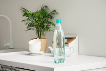 Bottle of water on table in kitchen, closeup