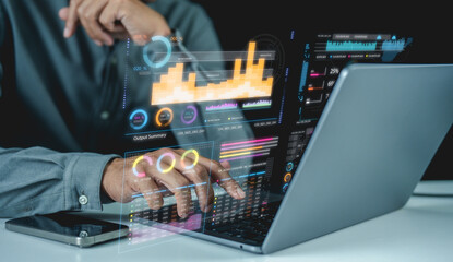 Businessman analyzes interactive digital data visualizations on a laptop, focusing on business analytics and statistics.