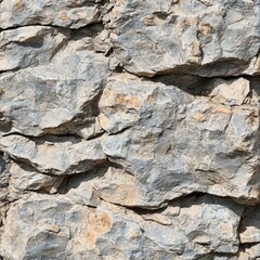 Rough, textured rock face with varied grey and beige tones.  Irregular shapes and crevices