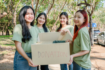 Happy Volunteers Donating Toys Outdoors, Diverse Group of Young Volunteers with Donation Boxes, Community Charity Event