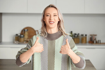 Mature mute woman using sign language at home