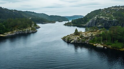 Fototapeta premium Aerial View of Serene Lake Landscape Surrounded By Green Trees and Hills