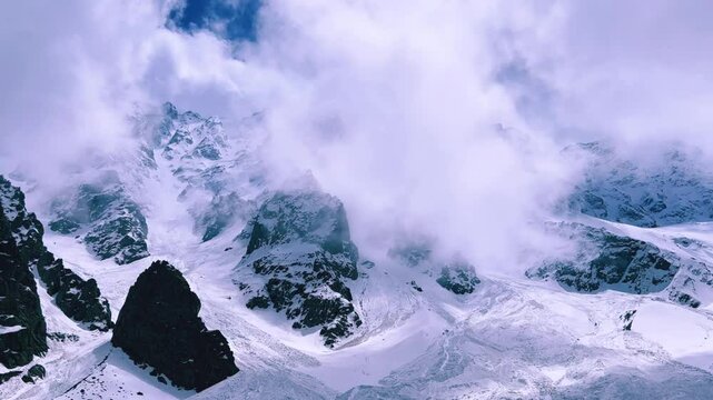 The Fairy Tale Gorge in Ossetia. Snowy mountains in the clouds. Mountain view near the Fairy Tale glacier, which is located in the Tsey Gorge in the North Caucasus. North Ossetia-Alania, Russia. 4К	