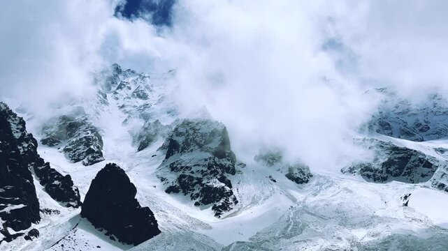 The Fairy Tale Gorge in Ossetia. Snowy mountains in the clouds. Mountain view near the Fairy Tale glacier, which is located in the Tsey Gorge in the North Caucasus. North Ossetia-Alania, Russia. 4К
