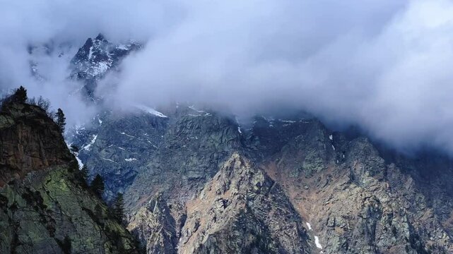 The Fairy Tale Gorge in Ossetia. Snowy mountains in the clouds. Mountain view near the Fairy Tale glacier, which is located in the Tsey Gorge in the North Caucasus. North Ossetia-Alania, Russia. 4К