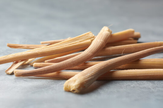 close-up of scattered odiyal or palmyra palm sprouts gray textured background, young shoots of palmyra tree, traditional sri lankan snack found in dry and coastal regions of southeast asia, soft focus