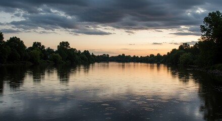 Fototapeta premium Peaceful river view during twilight hours with stunning cloud reflections