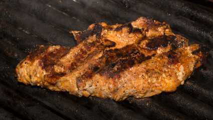 Roasting meat on the grill. Cooking fast food (barbecue) outside.
