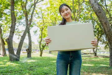 Happy Volunteers Donating Toys Outdoors, Young Volunteer with Donation Boxes, Community Charity Event