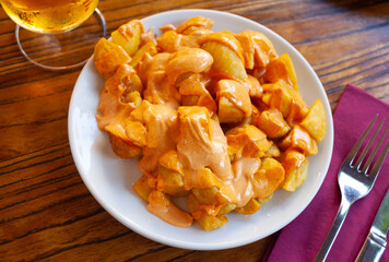 Appetizing spicy fried potatoes Patatas bravas with two sauces served as beer snack