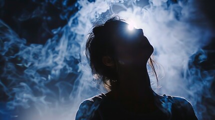 Woman Silhouette Lit By Bright Light Within Smoky Atmospheric Background