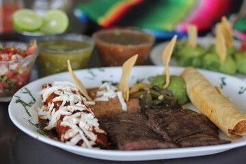 This image displays a tantalizing plate of traditional Mexican food, a tampiqueña, featuring an assortment of dishes that celebrate rich flavors and culinary heritage.