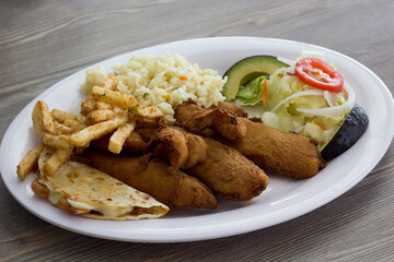A satisfying plate featuring crispy fried fish alongside seasoned rice and a fresh salad, capturing the essence of hearty and flavorful meals perfect for any occasion.