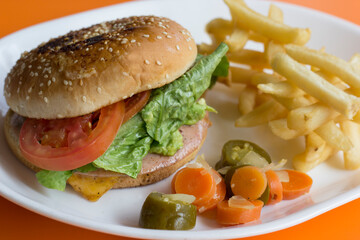 A classic burger sandwich layered with lettuce, tomato, cheese, and pickles on a sesame bun, served with crispy French fries for a delightful meal experience.