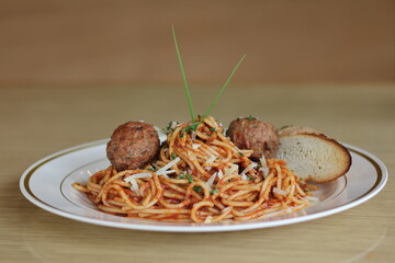 A classic Italian dish featuring spaghetti topped with rich tomato sauce and juicy meatballs,...